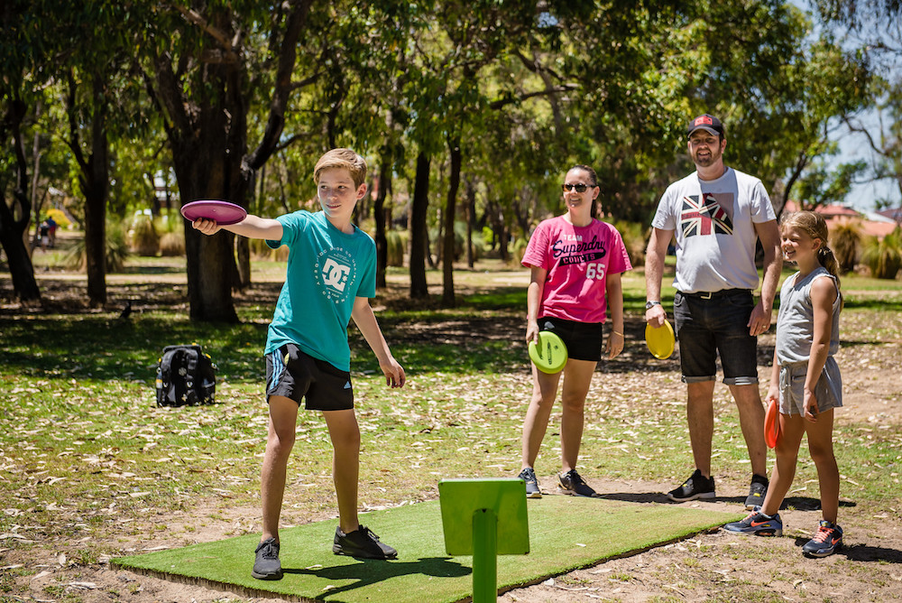 Friends playing disc golf